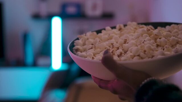 Woman running with popcorn in the living room