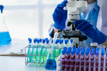 Doctor holding test tube with blue liquid, laboratory analysis for microscopic test in hospital laboratory