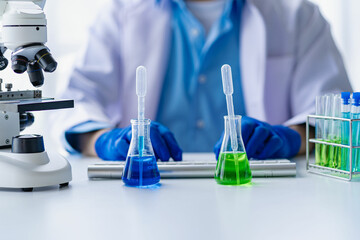 Doctor holding test tube with blue liquid, laboratory analysis for microscopic test in hospital laboratory