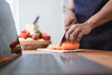 Portrait of asian man making salad at home. cooking food and Lifestyle moment