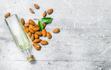 Almond oil in a glass bottle .