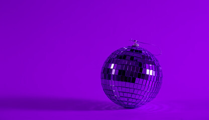 Disco ball on a blurred purple background, the concept of dancing, disco, music and parties, copy space.