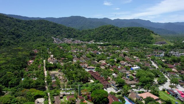 Aerial view flying over the Barra Do Sahy village, in sunny Sao sebastiao, Brazil