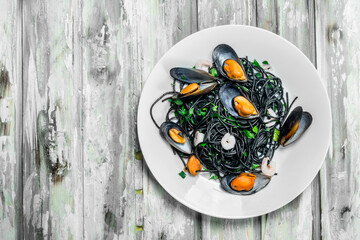 Mediterranean pasta. Spaghetti with cuttlefish ink and clams.
