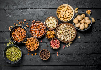Assortment of different nuts in bowls.