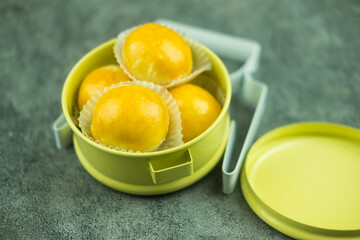 Chinese dessert puffs, bean cakes with salted egg yolks put in tiffin carrier.
