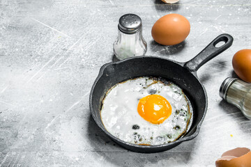 Fried egg with salt and black pepper.