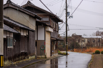 Fototapeta na wymiar Old wooden Japanese house in rural village on a rainy day