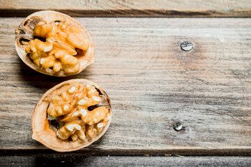 Peeled walnut on wooden board .