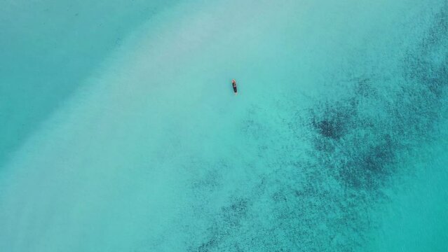 stand up paddling sub in Turquoise crystal clear water. Buttery soft aerial view flight vertical bird's eye view drone beach formentera island ibiza spain, fall 2022. High Quality 4k Cinematic footage