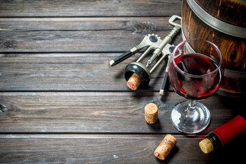 Wine background. A barrel of red wine with a corkscrew.