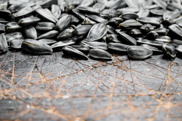 Sunflower seeds on wooden background.