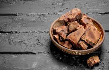 Crushed dark chocolate in a bowl .