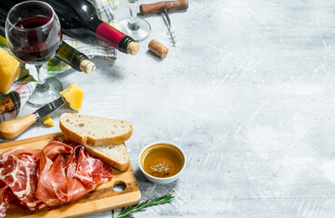 Antipasto background. Red and white wine with meat and cheese appetizers.