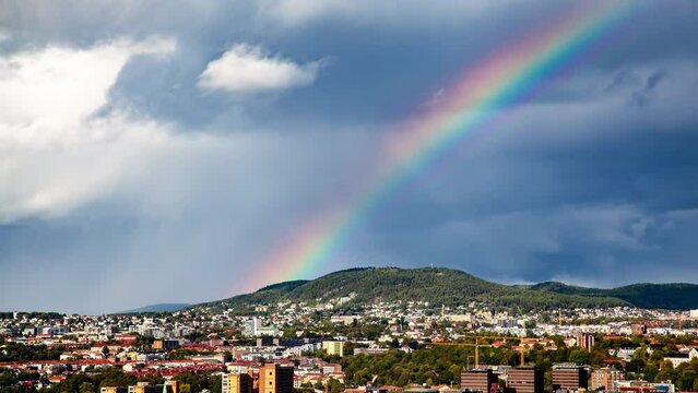 Bright real rainbow above Oslo city Timelapse skyline