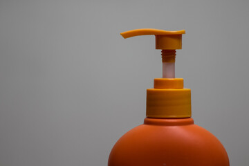 Fototapeta na wymiar Picture Of Orange Pump Head Shower Gel 