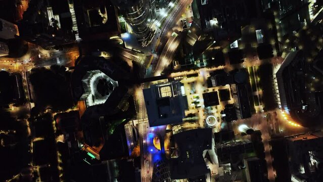 Top-down aerial shot of Paris Downtown skyline buildings, roads illuminated with night light