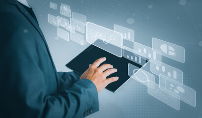 Businessman using tablet in data management. Business, technology, internet and networking concept.