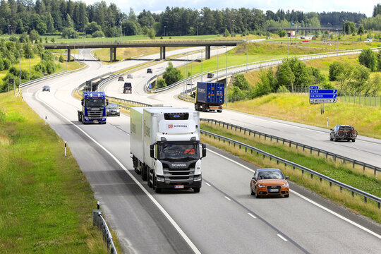 Scania Freight Trucks Transport Goods on Motorway on a Day of Summer. 