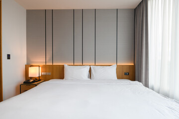 Warm and cozy interior of bedding room space with bed. Cozy home decor.