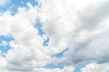 Nature background from white clouds in sunny day. Beautiful white fluffy clouds in blue sky.