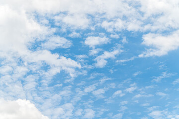 Nature background from white clouds in sunny day. Beautiful white fluffy clouds in blue sky.