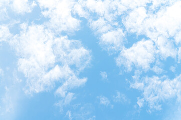 Nature background from white clouds in sunny day. Beautiful white fluffy clouds in blue sky.