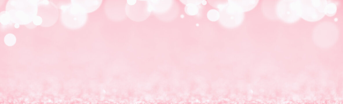 St Valentines day pink background top border wide banner. Love or wedding concept with bokeh lights blurred defocused glitter