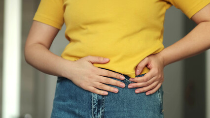 Woman touching his stomach. Stomach pain and others stomach disease concept.Girl having a stomachache. Young woman suffering from abdominal pain. Woman Stomach Ache.