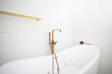 A view of a stylish freestanding bathtub in a bathroom lifestyle setting.