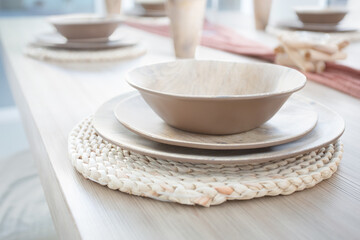 A view of a styled home dining table with place settings.