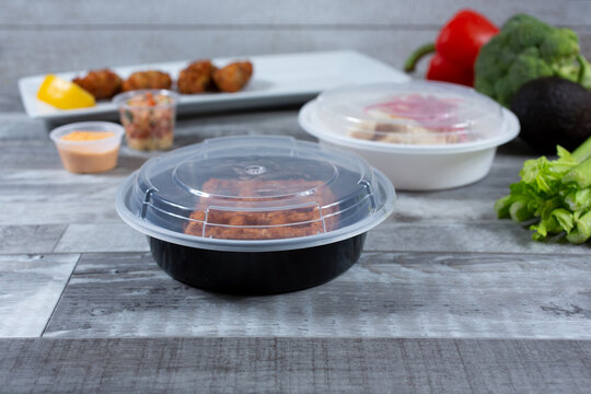A view of food in several to-go plastic containers.