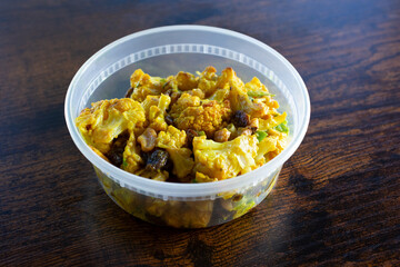 A view of a container of roasted cauliflower salad.