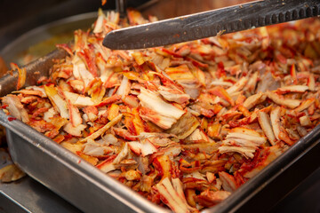 A view of a large tub full of chicken shawarma trimmings.