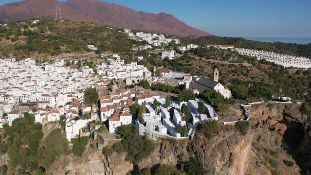 Spectacular view from drone of old white-washed houses of clifftop village of Casares at sunny day, Spain