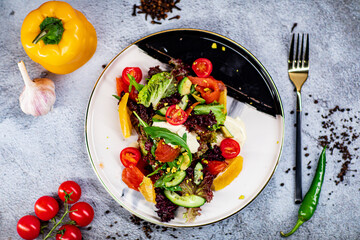 salad with salmon, avocado, cucumber, cherry, lemon and pistachios