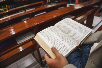 The person reading a bible in the church