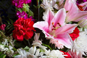 A view of a pink and white floral arrangement, featuring lily, carnation, chrysanthemum.
