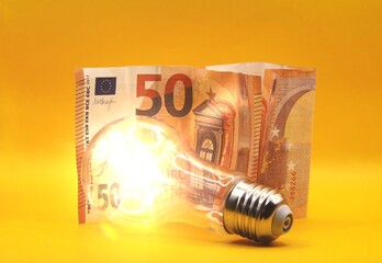 Light bulb with euro money concept of raising price of electricity.
