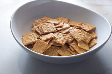 A view of a bowl of gluten-free rice crackers.
