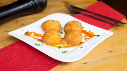 Spanish croquettes tapa. The croquette is a portion of dough made from a dense sauce such as...