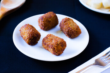 Spanish croquettes tapa. The croquette is a portion of dough made from a dense sauce such as bechamel and a mincemeat of various ingredients.