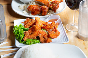 A view of a plate of deep fried coconut shrimp.