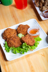 A view of a plate of deep fried tofu nuggets.