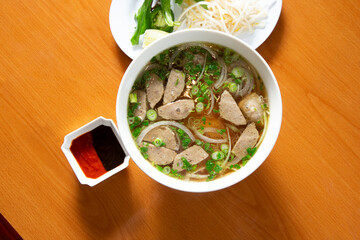 A top down view of a bowl of meatball pho, or pho bo vien.