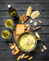 Delicious fondue cheese with white wine. - 561713064