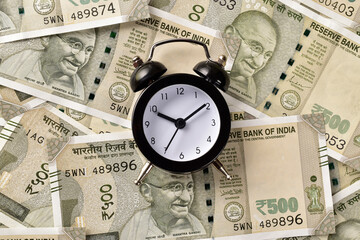 Clock with money, indian mutual fund and investment concept