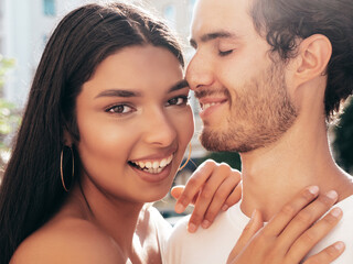 Smiling beautiful woman and her handsome boyfriend. Happy cheerful family. Sexy couple posing in the street at sunrise. During romantic date at sunny summer day outdoors. Looking at each other