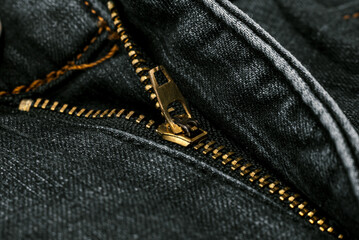 Naklejka premium Closeup of zipper in blue jeans. Zipper with lock. A piece of denim