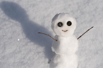 Snow man isolated on snow background. Christmas Greeting Card with snowman.